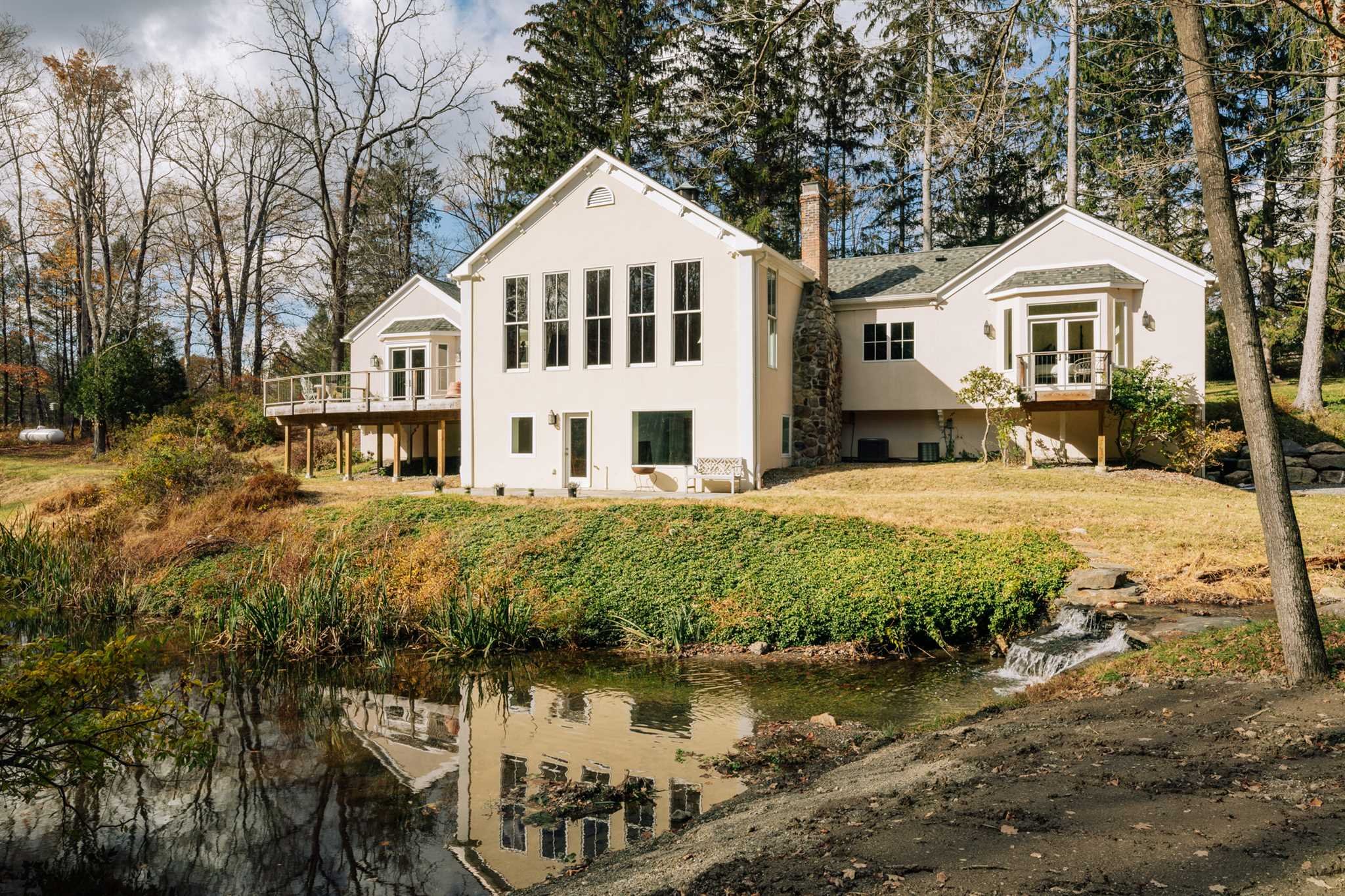 18 Altamont Road Millbrook, NY 12545 - Photo 4 of 35 a view of a white house with a yard table and chairs
