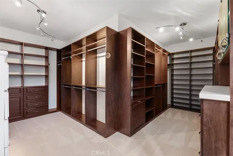 a dining room with furniture and a kitchen area