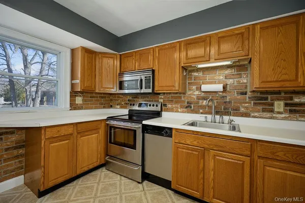 a kitchen with stainless steel appliances granite countertop a sink stove microwave and cabinets