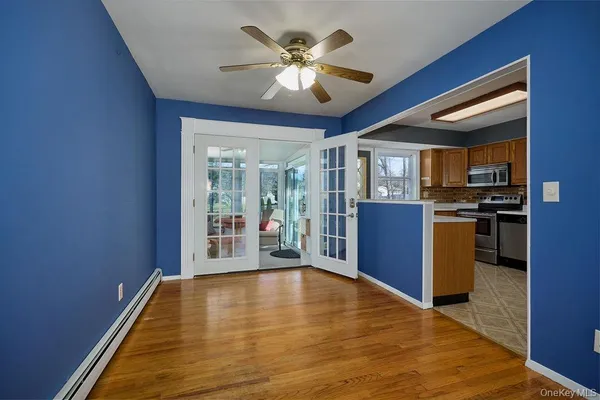 a view of kitchen with refrigerator and stove