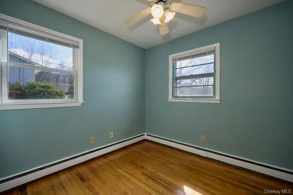 a view of a room with wooden floor and a window