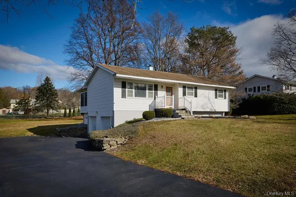 a view of a house with pool and fire pit