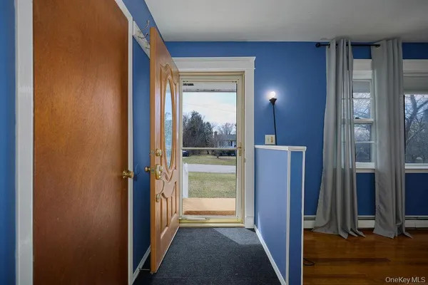 a view of a hallway with a glass door and door in a room