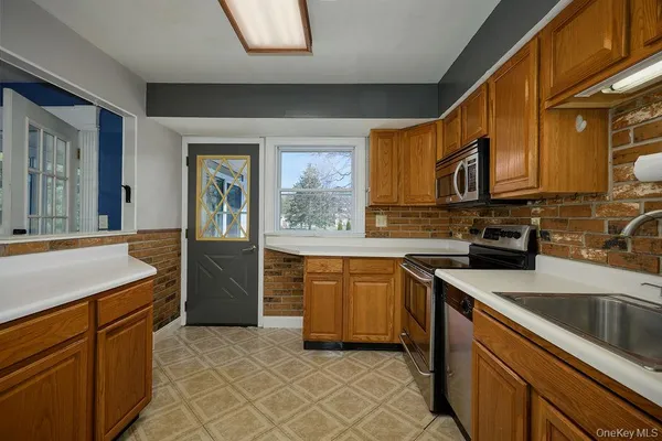 a kitchen with stainless steel appliances granite countertop a sink and cabinets