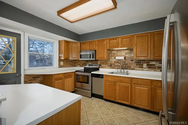 a kitchen with a sink stove and microwave