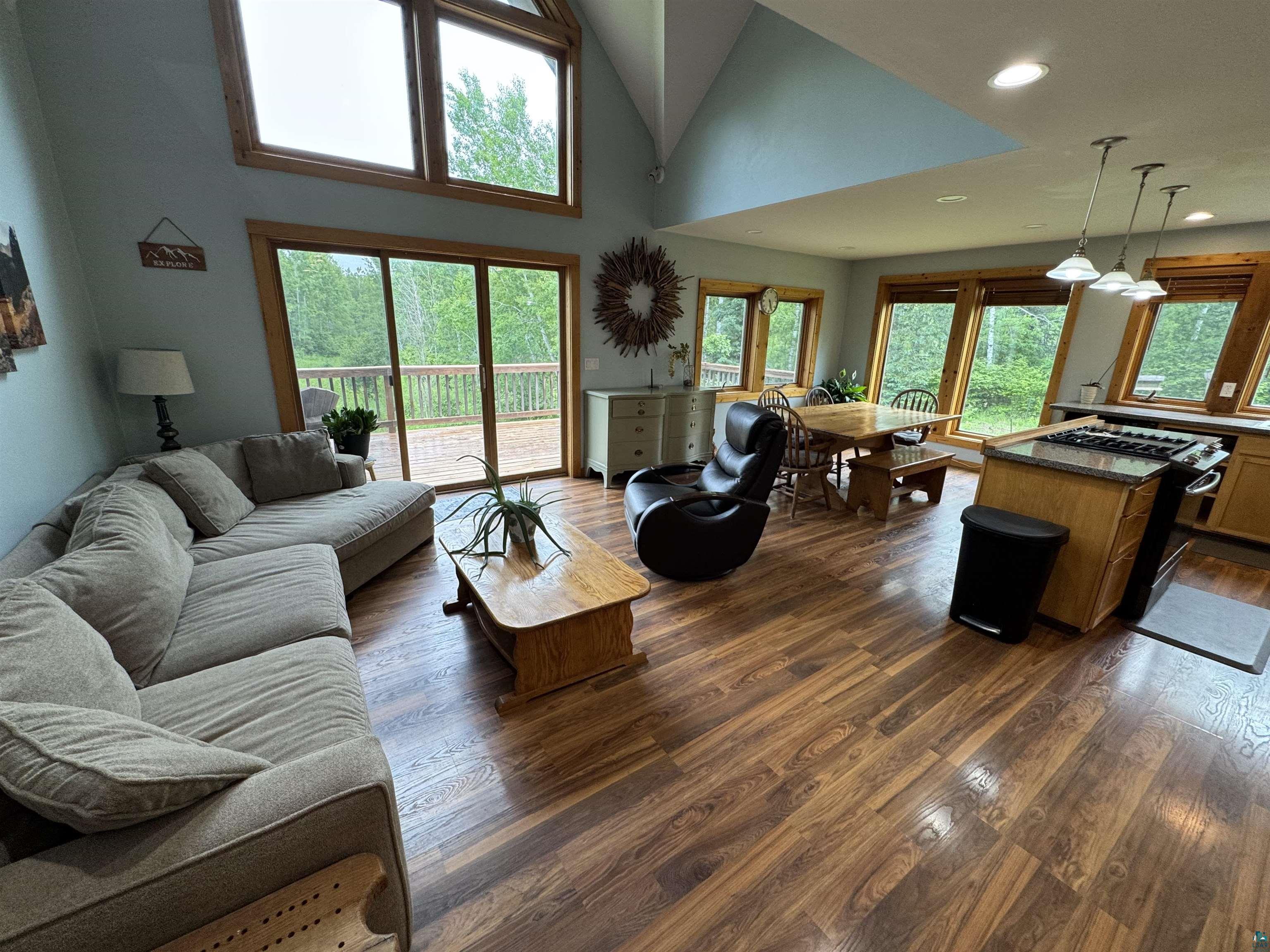 1745 Becks Road Maple, WI 54854 - Photo 13 of 46 Open-concept living area featuring wood-finish flooring, a vaulted ceiling, and recessed lighting
