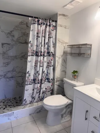 a bathroom with a toilet and a shower