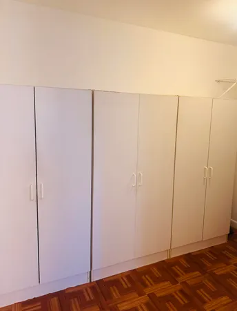 a view of a room with wooden floor