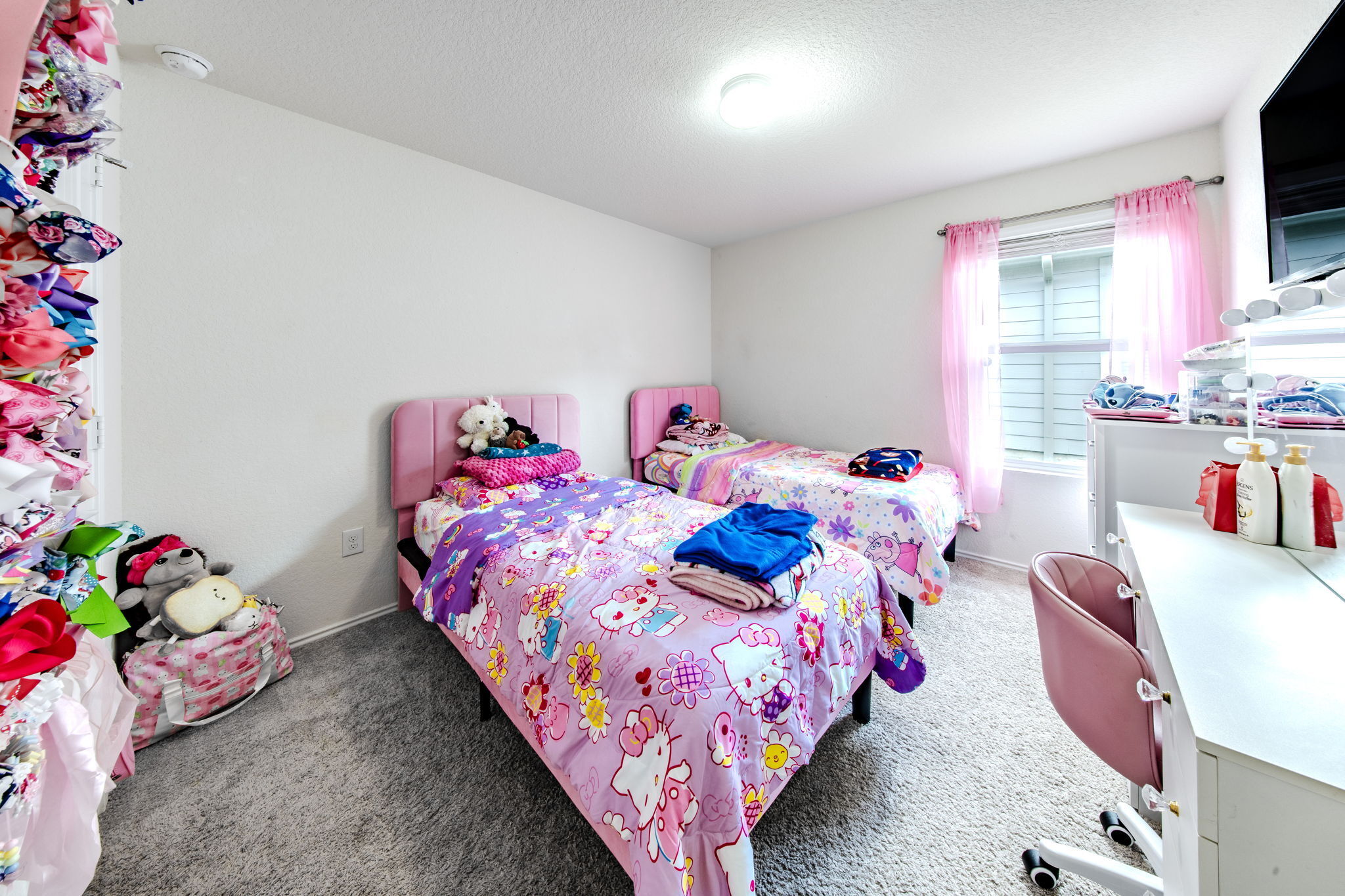 14903 Tuff Road Manor, TX 78653 - Photo 12 of 25 A well-lit bedroom features plush carpeting and a bright window with horizontal blinds.