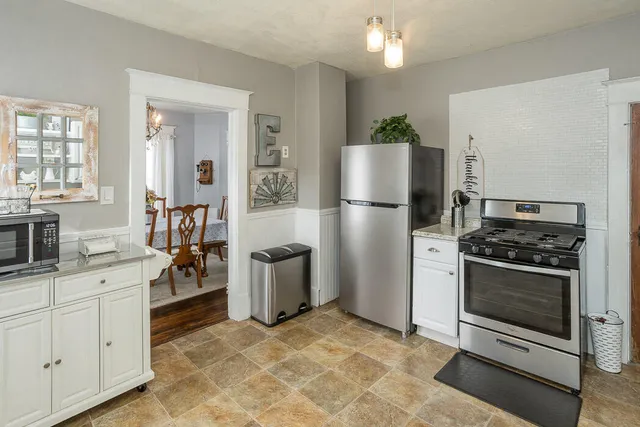 a kitchen with stainless steel appliances a refrigerator sink and stove