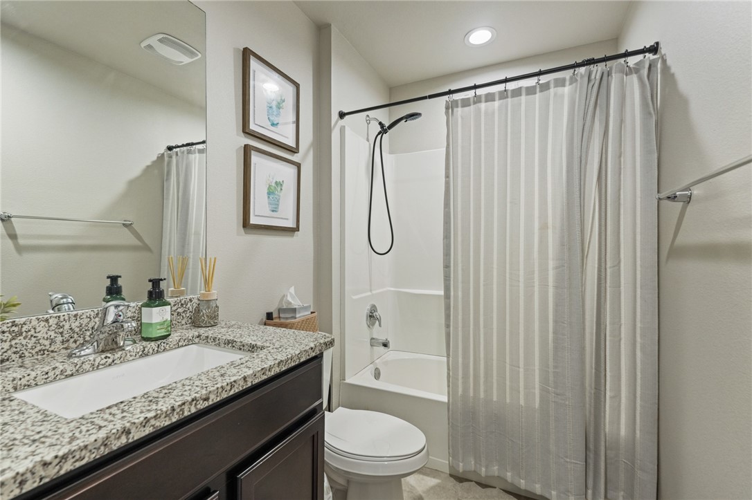 103 Donegal Street Sinton, TX 78387 - Photo 16 of 29 a bathroom with a granite countertop sink toilet and shower