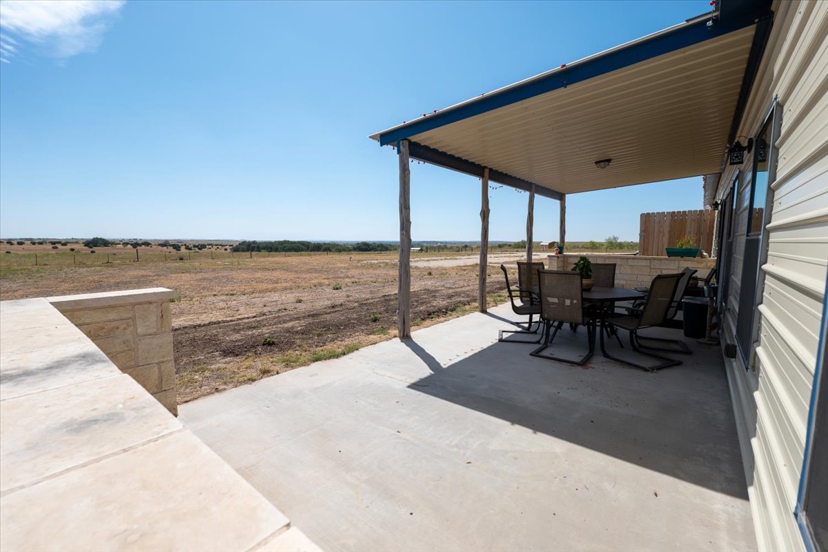 1825 Savanna Ridge Ranch Road Lometa, TX 76853 - Photo 28 of 35 View of patio featuring outdoor dining space and a rural view