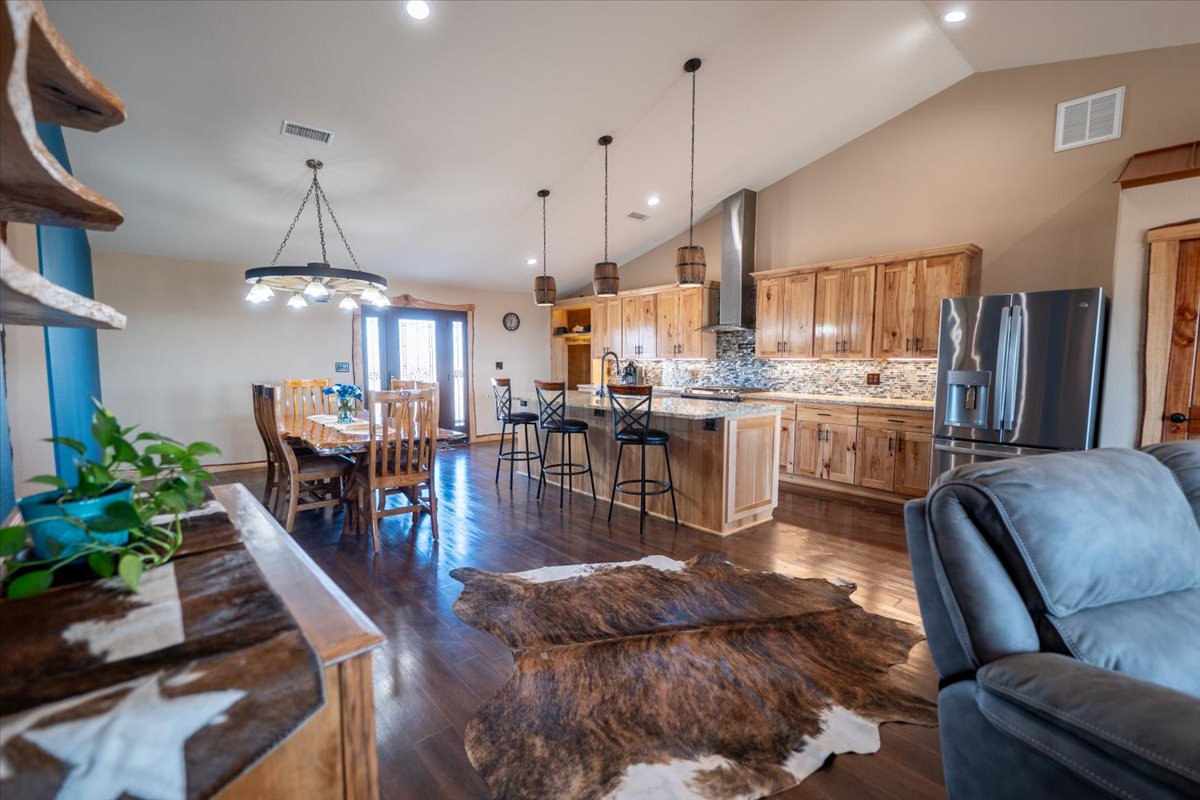 1825 Savanna Ridge Ranch Road Lometa, TX 76853 - Photo 3 of 35 a living room with stainless steel appliances furniture a chandelier a kitchen view and a chandelier