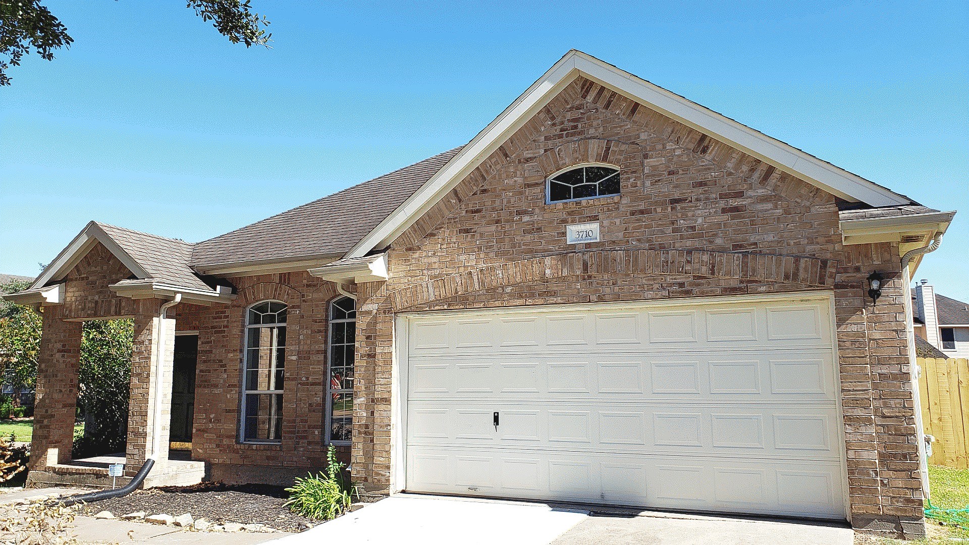 a front view of a house with garage