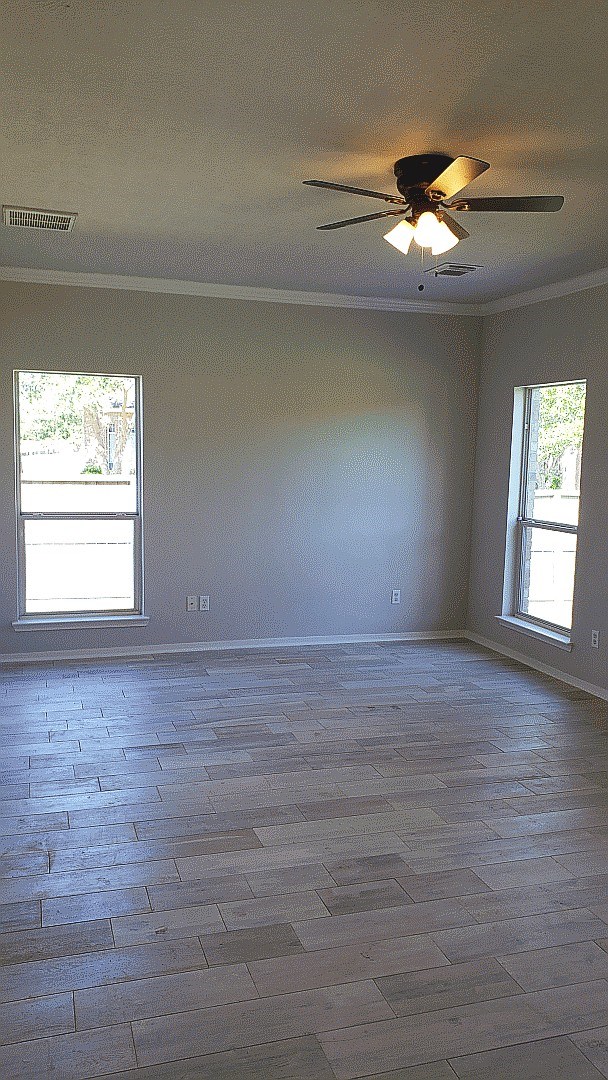 3710 Ransom Road Richmond, TX 77469 - Photo 32 of 42 en empty room with window and wooden floor