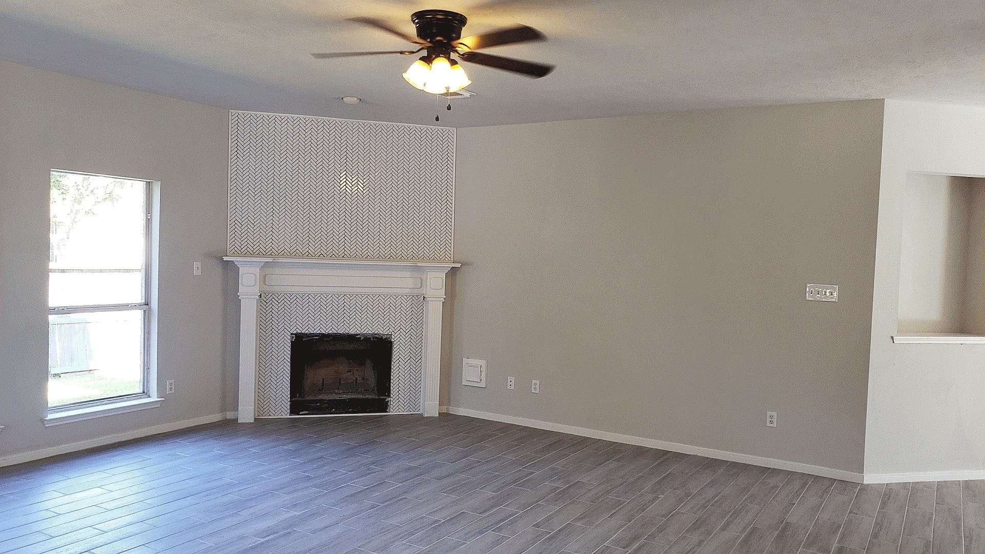 3710 Ransom Road Richmond, TX 77469 - Photo 7 of 42 an empty room with wooden floor fan and windows
