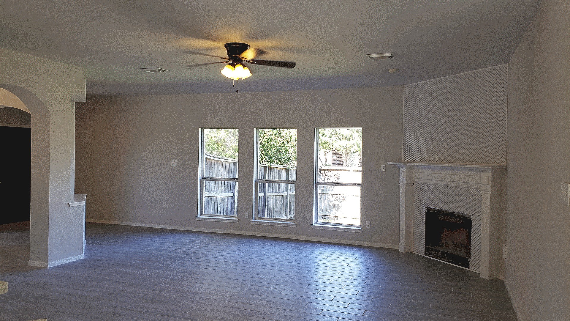 3710 Ransom Road Richmond, TX 77469 - Photo 8 of 42 an empty room with wooden floor fan and windows