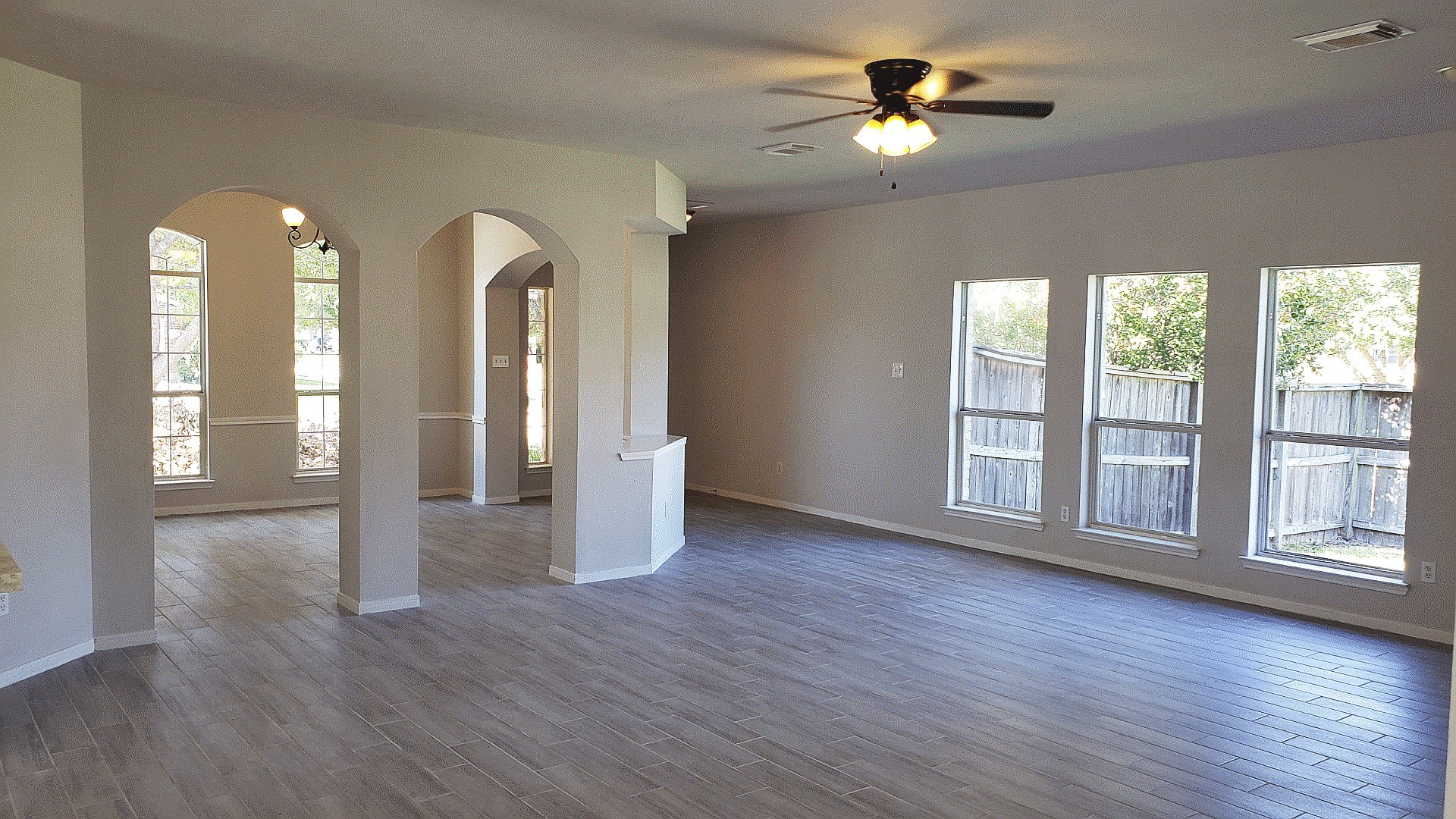 3710 Ransom Road Richmond, TX 77469 - Photo 9 of 42 a view of an empty room with a window and wooden floor