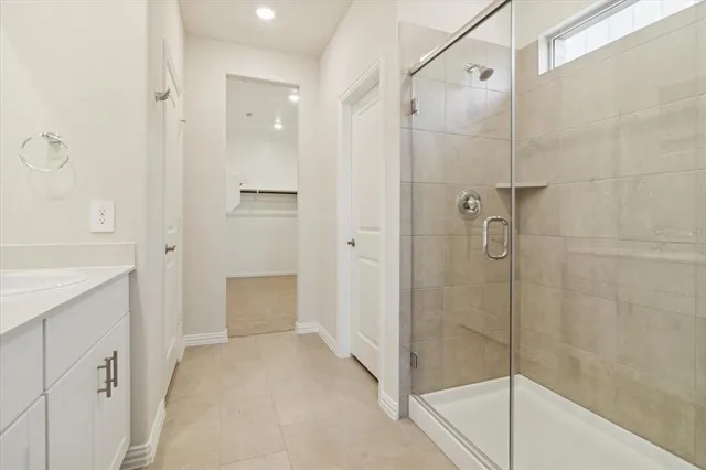 a bathroom with a shower and a sink