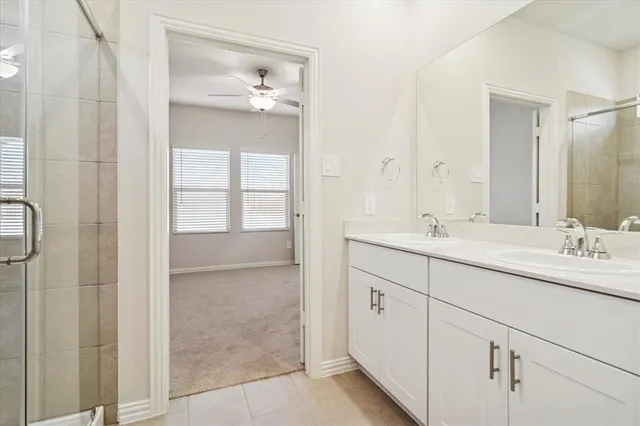 a bathroom with a double vanity sink and mirror