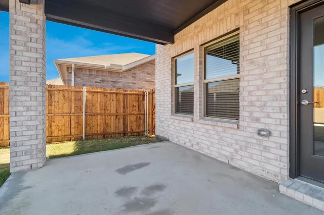 a view of a brick house with a large window
