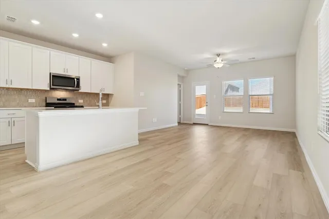 a view of a kitchen with microwave and cabinets