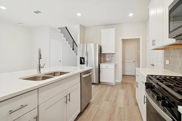 a kitchen with a sink stove and refrigerator