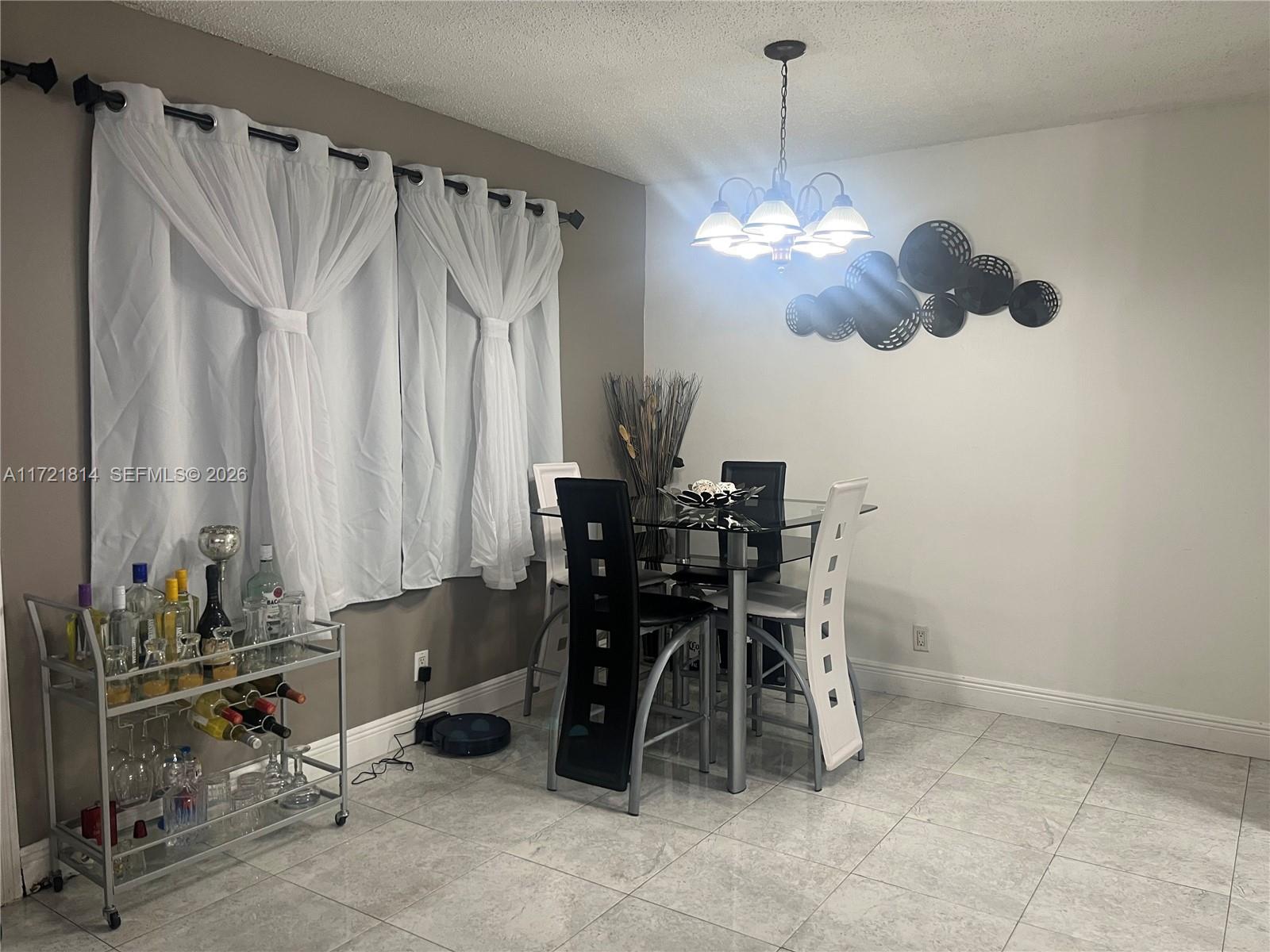8710 Southwest 3rd Street, Unit 104 Pembroke Pines, FL 33025 - Photo 18 of 46 a dining room with a table and chairs