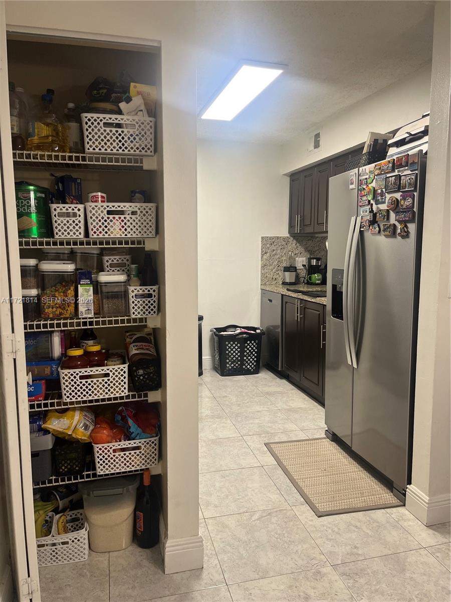 8710 Southwest 3rd Street, Unit 104 Pembroke Pines, FL 33025 - Photo 23 of 46 a kitchen with stainless steel appliances granite countertop a refrigerator and a stove