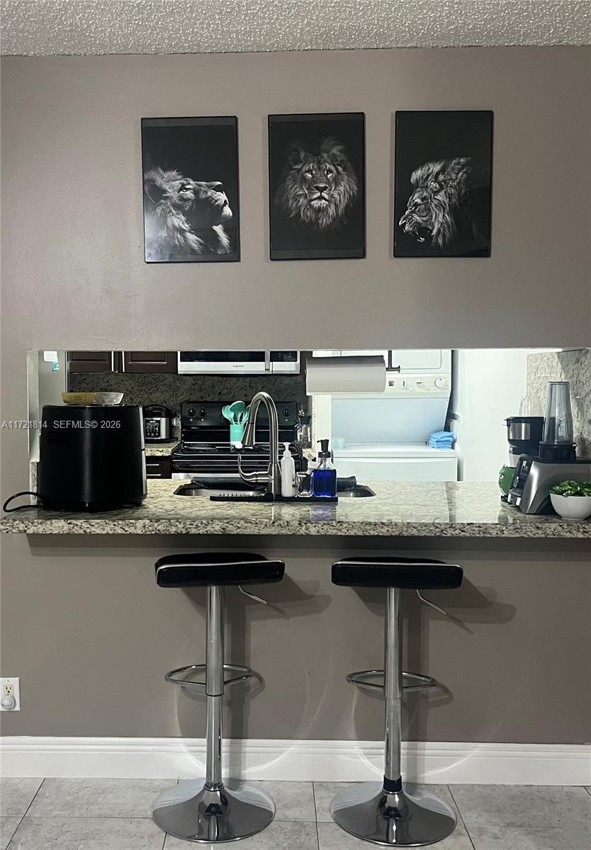 8710 Southwest 3rd Street, Unit 104 Pembroke Pines, FL 33025 - Photo 25 of 46 a room with furniture and chairs