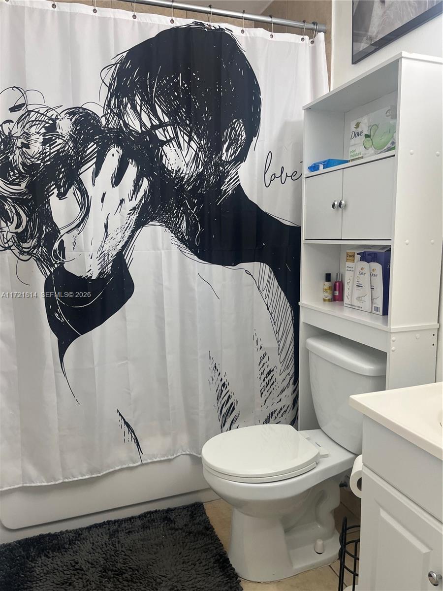 8710 Southwest 3rd Street, Unit 104 Pembroke Pines, FL 33025 - Photo 29 of 46 a white toilet sitting next to a bathroom sink