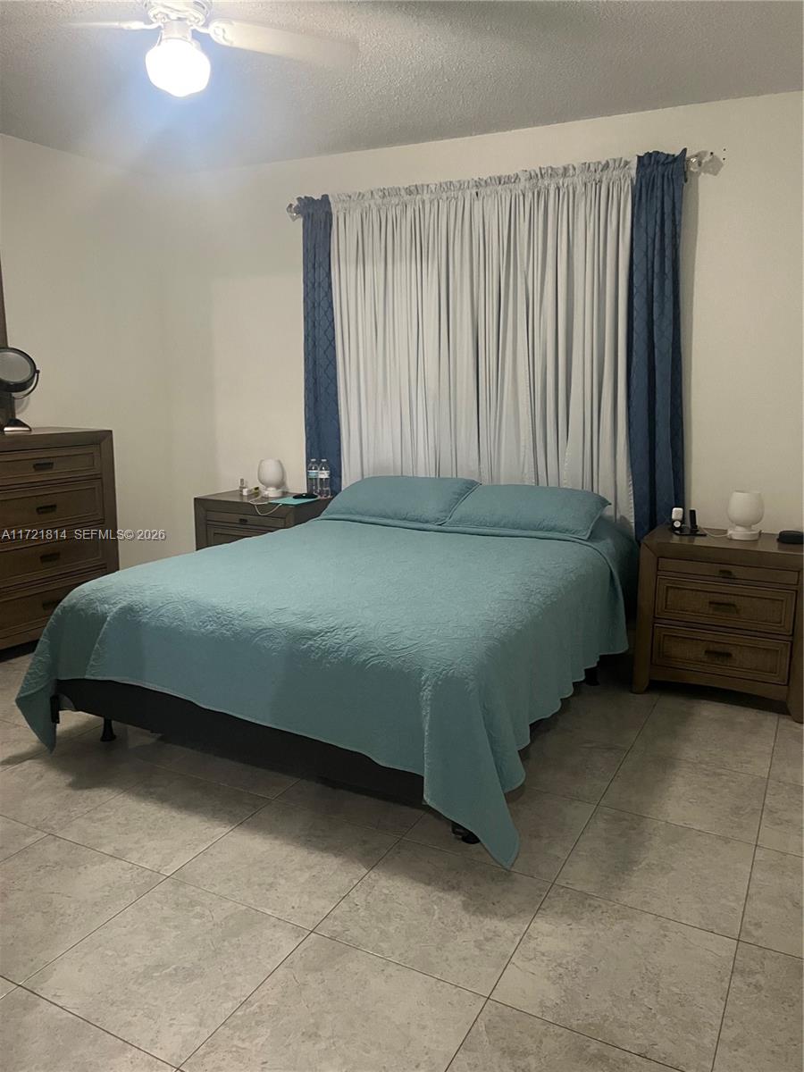 8710 Southwest 3rd Street, Unit 104 Pembroke Pines, FL 33025 - Photo 30 of 46 a bedroom with a bed and a cabinets