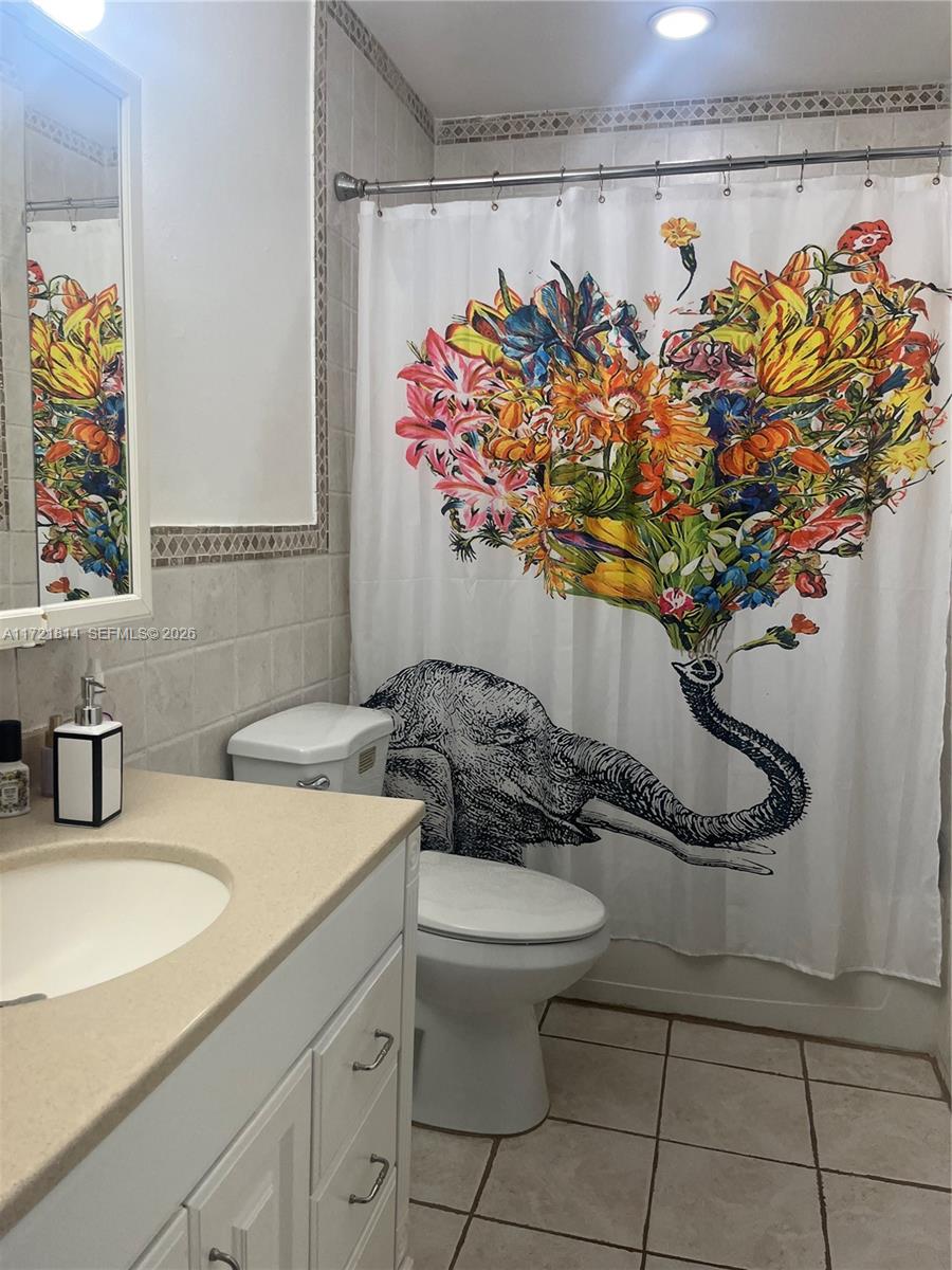 8710 Southwest 3rd Street, Unit 104 Pembroke Pines, FL 33025 - Photo 32 of 46 a bathroom with a toilet sink and mirror