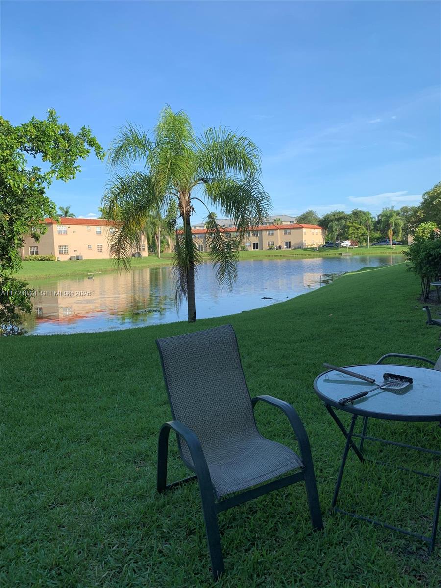 8710 Southwest 3rd Street, Unit 104 Pembroke Pines, FL 33025 - Photo 35 of 46 a view of a chairs and table on the green field and grass