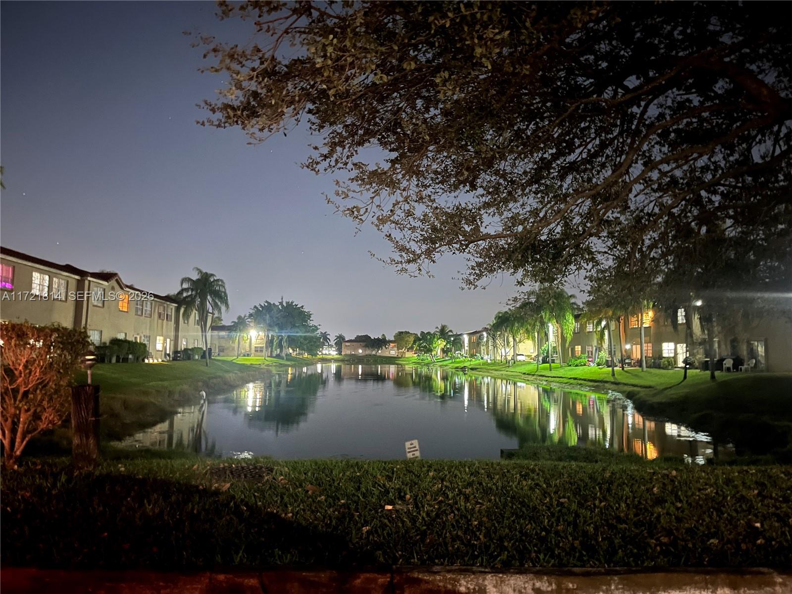 8710 Southwest 3rd Street, Unit 104 Pembroke Pines, FL 33025 - Photo 39 of 46 a view of a lake in front of house with trees