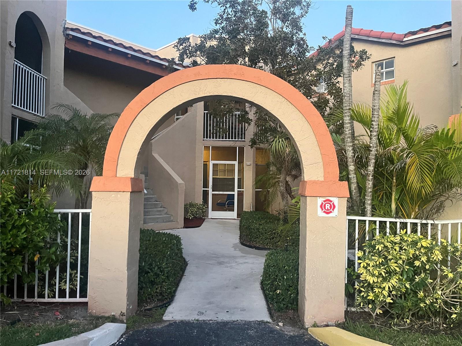8710 Southwest 3rd Street, Unit 104 Pembroke Pines, FL 33025 - Photo 9 of 46 a front view of a house with garden