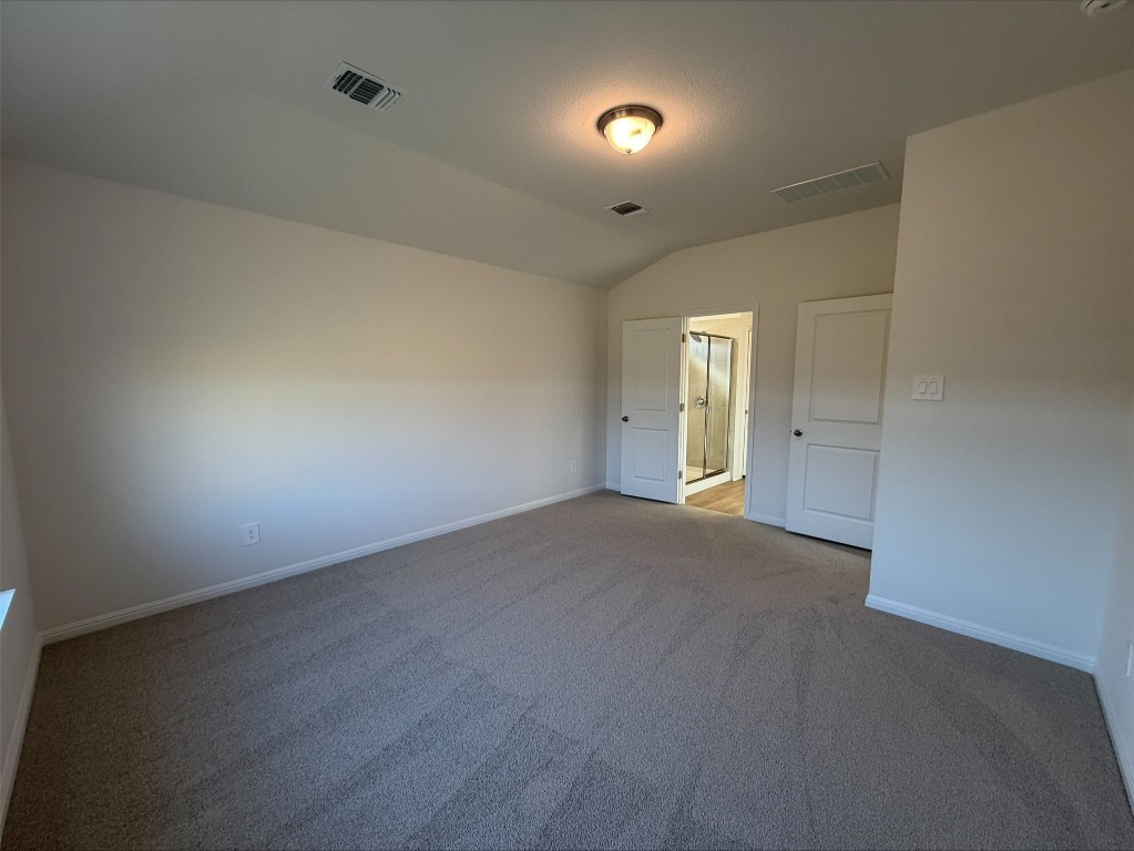 108 Honey Bee Road Jarrell, TX 76537 - Photo 6 of 9 Unfurnished bedroom with vaulted ceiling and carpet flooring