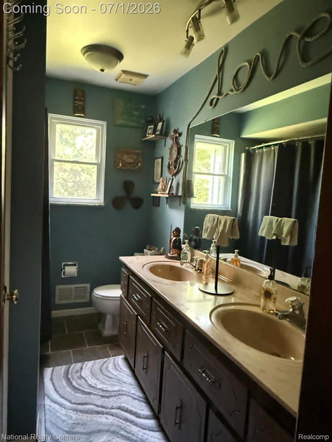 1330 Brauer Road Oxford, MI 48371 - Photo 49 of 54 Dual vanity with integrated sinks, dark wood-finish cabinetry, and a full-width mirror