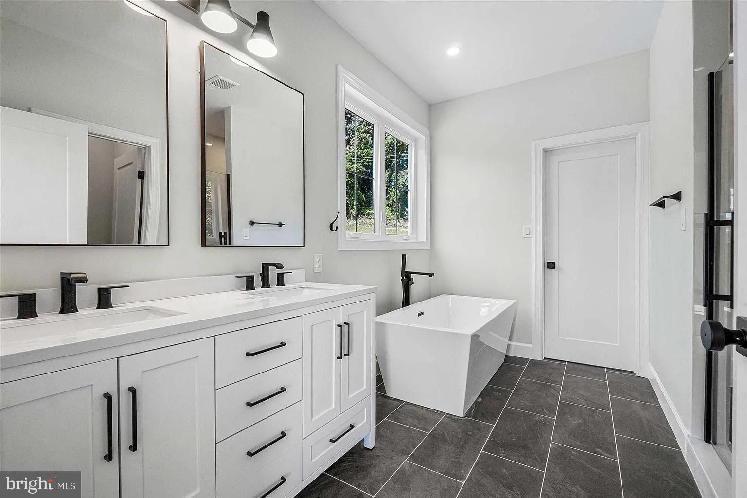 0 Brenneman Road Glen Rock, PA 17327 - Photo 13 of 24 a bathroom with a double vanity sink a mirror and a bathtub
