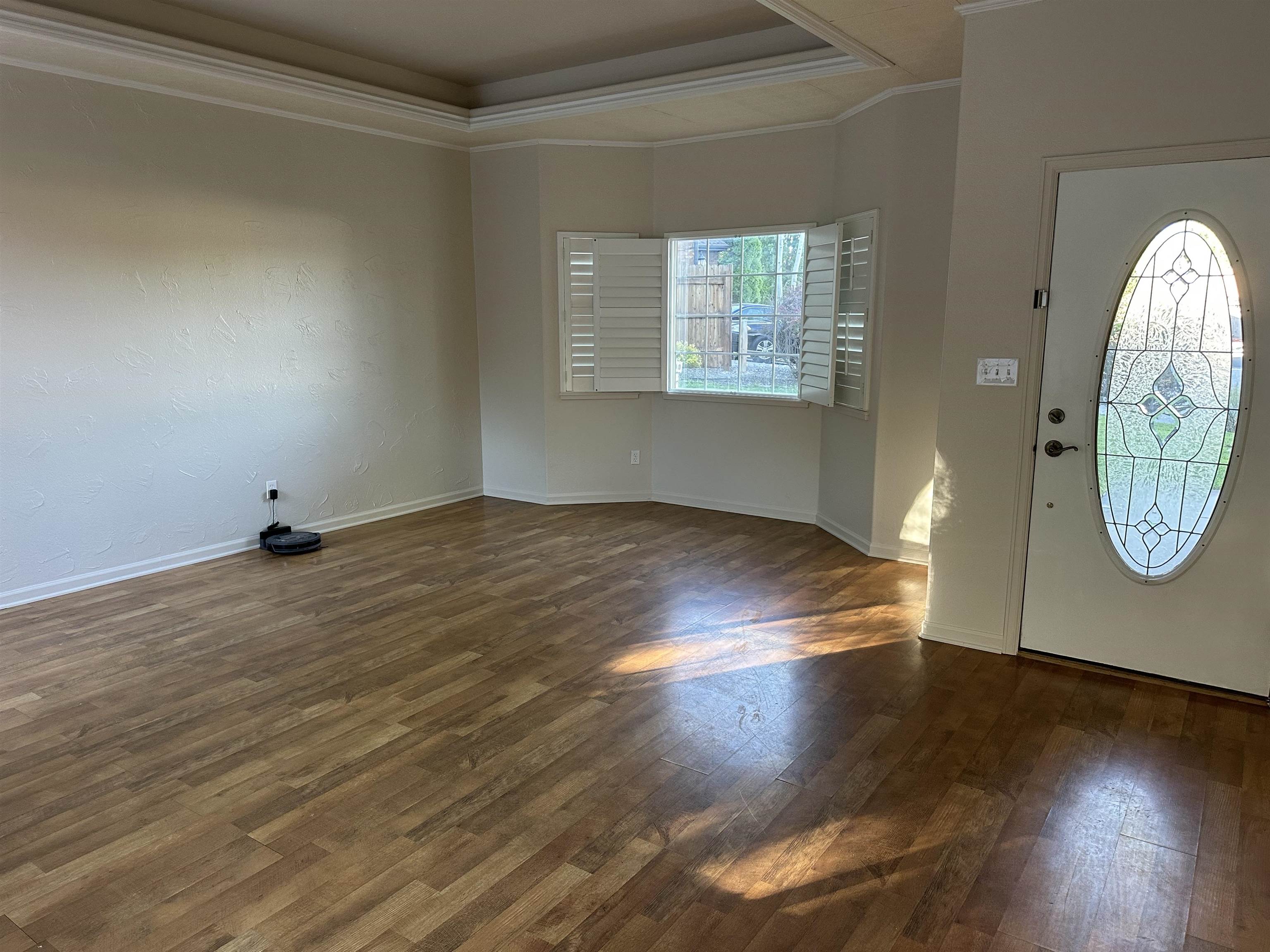 2678 Cambridge Road Grand Junction, CO 81506 - Photo 10 of 32 an empty room with wooden floor mirror and windows