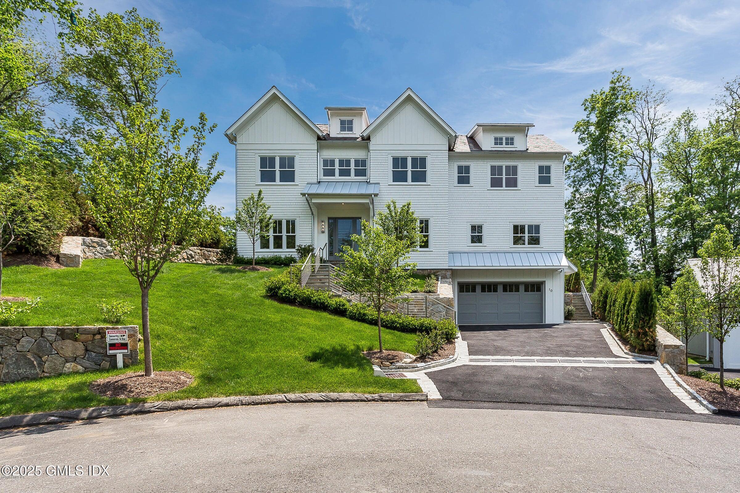 10 Lakeview Drive Riverside, CT 06878 - Photo 1 of 1 a front view of a house with a yard and trees