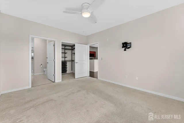 an empty room with closet and windows