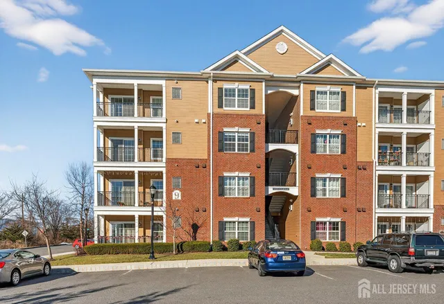 a front view of a residential apartment building with a yard