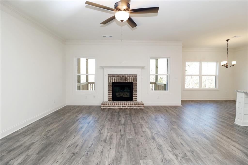 457 Banff Drive Winder, GA 30680 - Photo 12 of 12 an empty room with wooden floor windows and fireplace