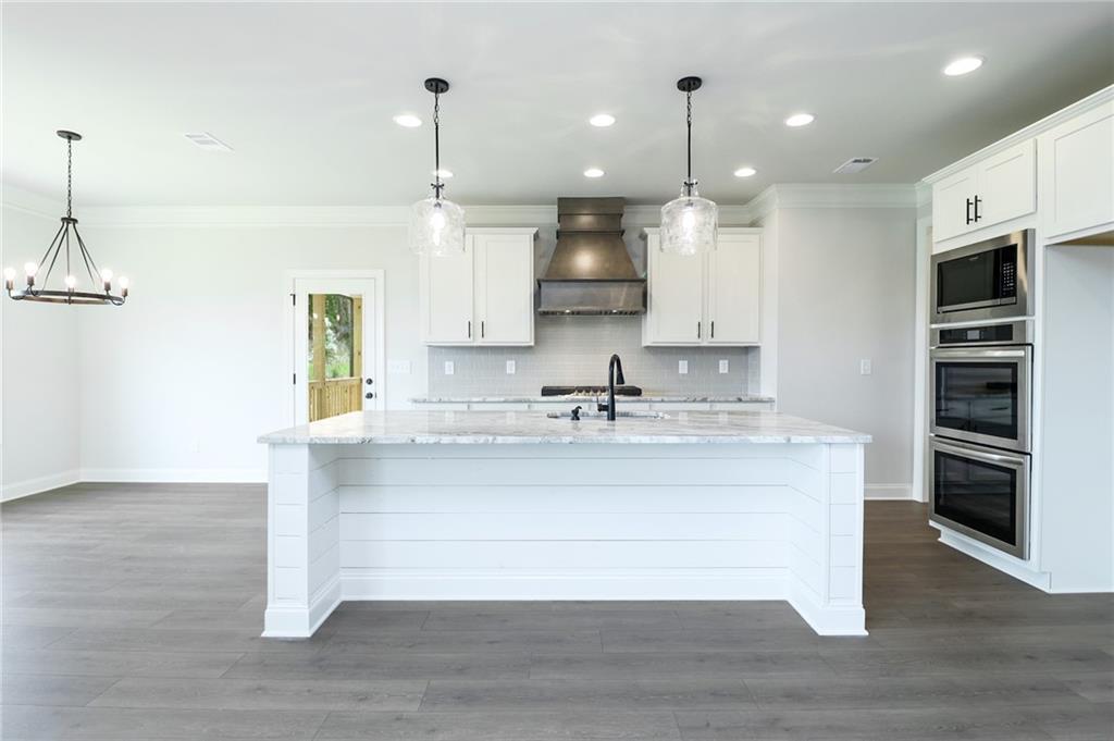457 Banff Drive Winder, GA 30680 - Photo 5 of 12 a large white kitchen with stainless steel appliances