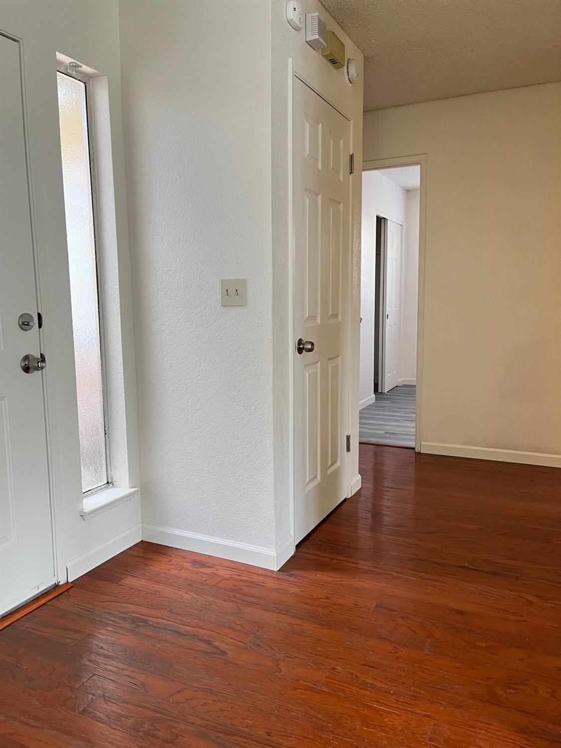 Undisclosed Address Sacramento, CA 95828 - Photo 1 of 1 a view of a hallway with wooden floor