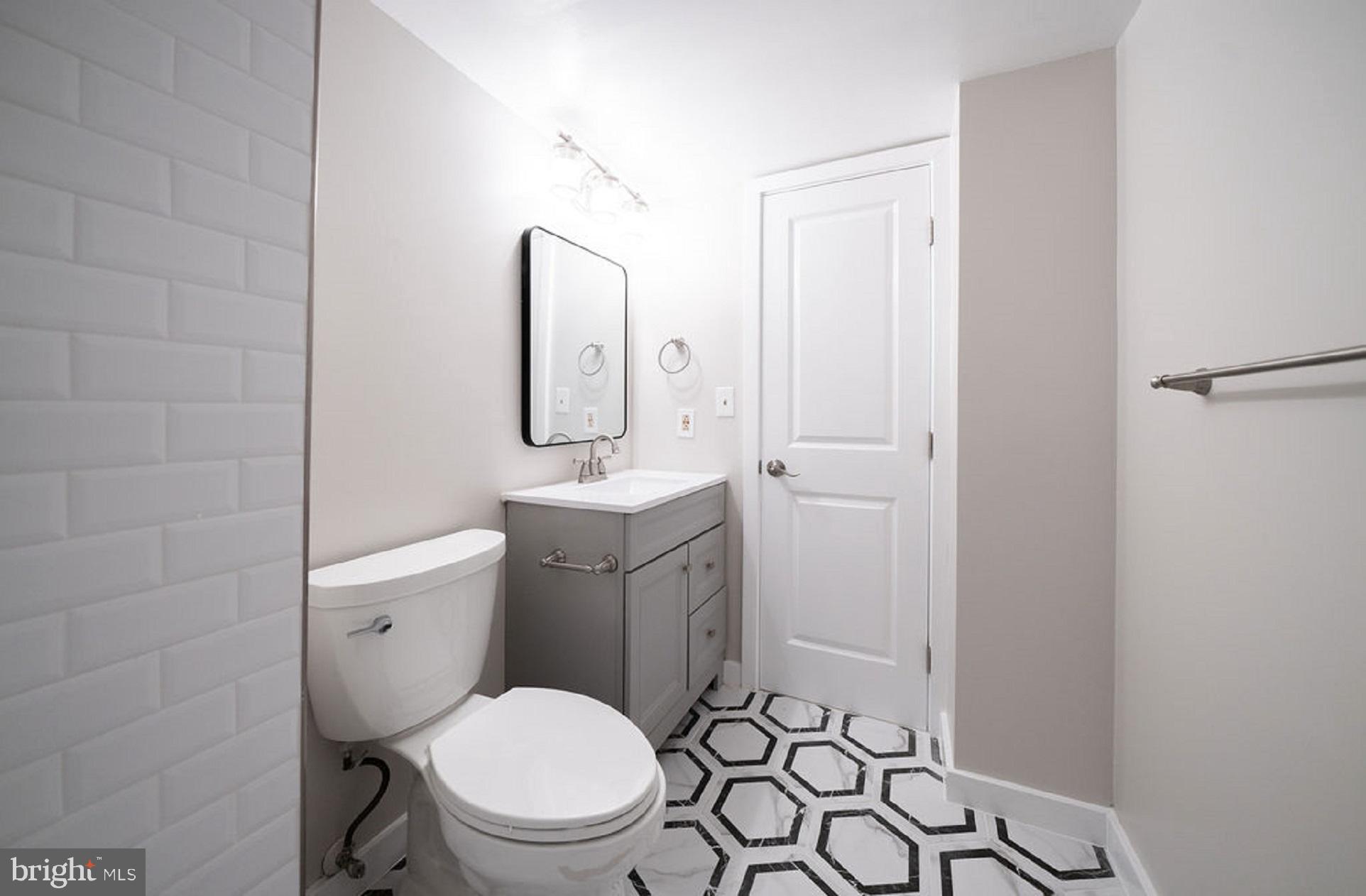 5505 Seminary Road, Unit 103N Falls Church, VA 22041 - Photo 29 of 59 a bathroom with a toilet sink vanity and mirror