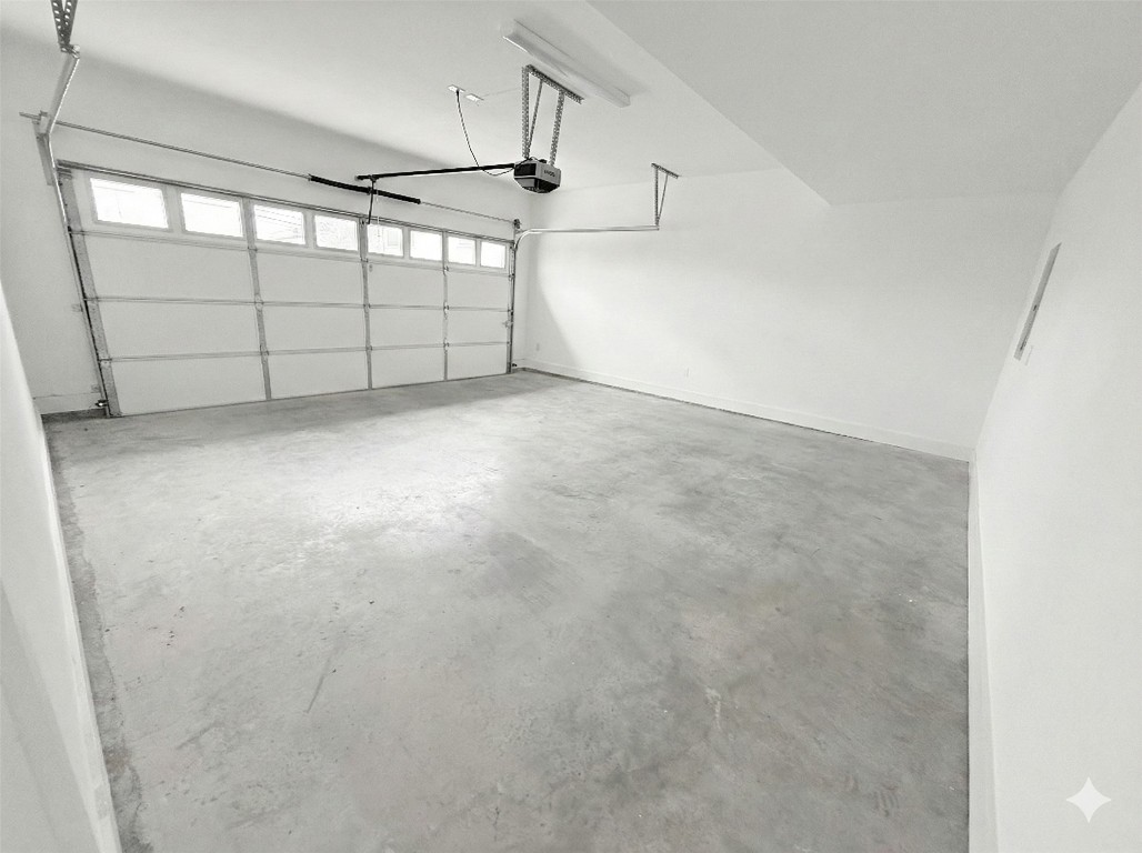 1417 Kramer Lane, Unit 20 Austin, TX 78758 - Photo 13 of 14 Garage featuring a garage door opener