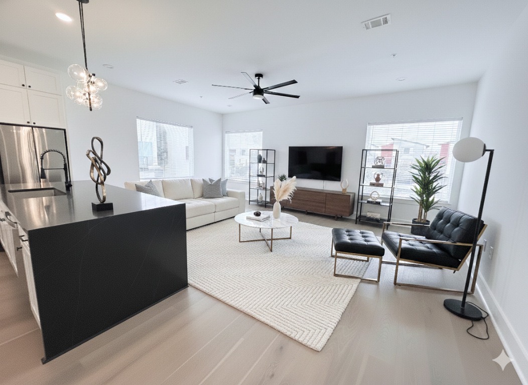 1417 Kramer Lane, Unit 20 Austin, TX 78758 - Photo 2 of 14 Living room featuring light wood-style floors, a ceiling fan, a chandelier, and recessed lighting