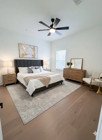 a bedroom with a bed couch and window